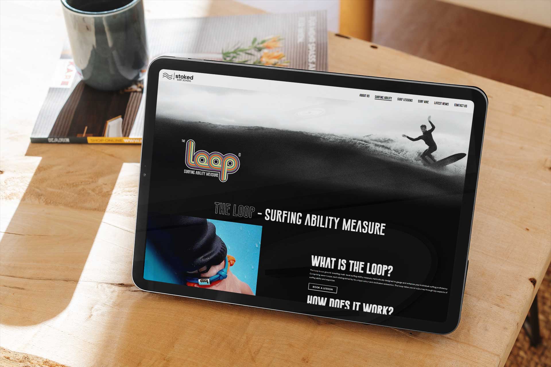Stoked Surf School's website on a tablet