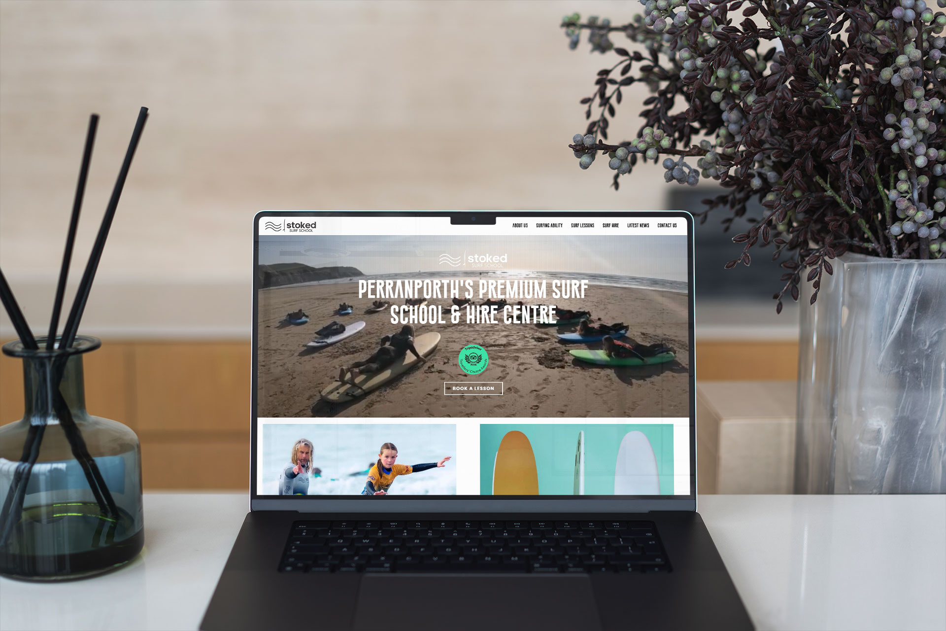Stoked Surf School's website on a laptop screen