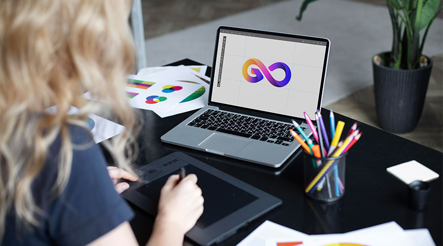 A woman sat designing a logo