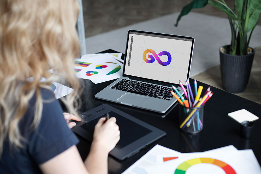 A woman sat designing a logo