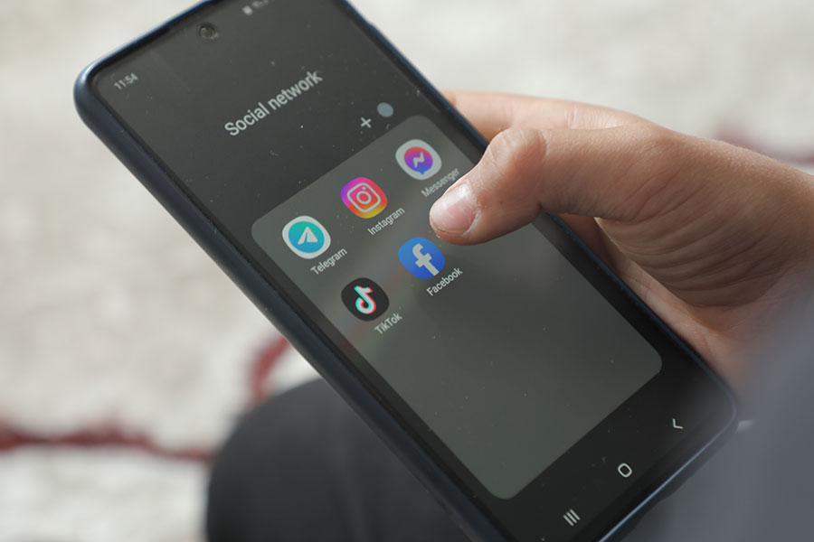 A person accessing social media on their mobile phone