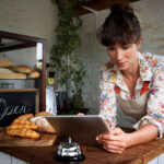 A woman on a tablet looking at her small business website