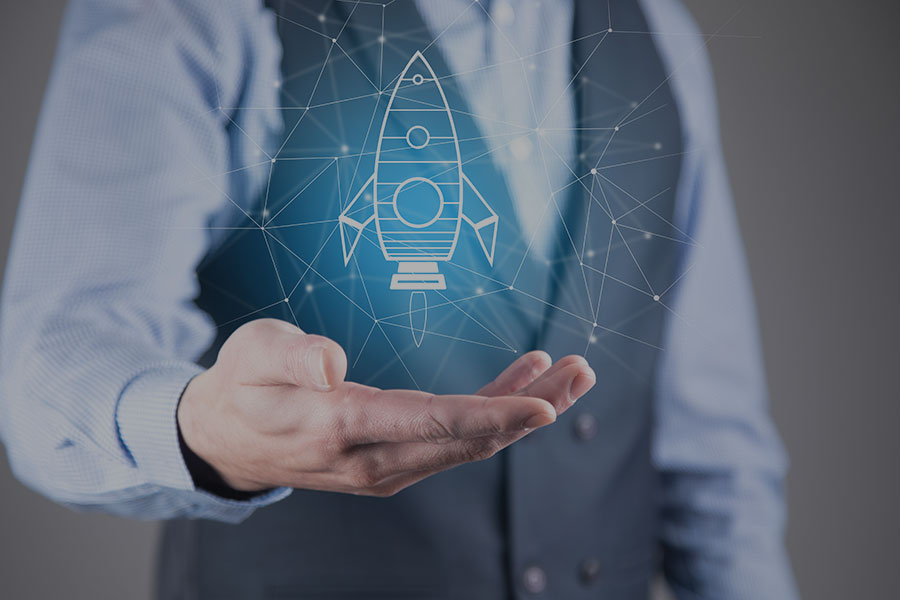 A man holding a digital rocket, representing a business startup