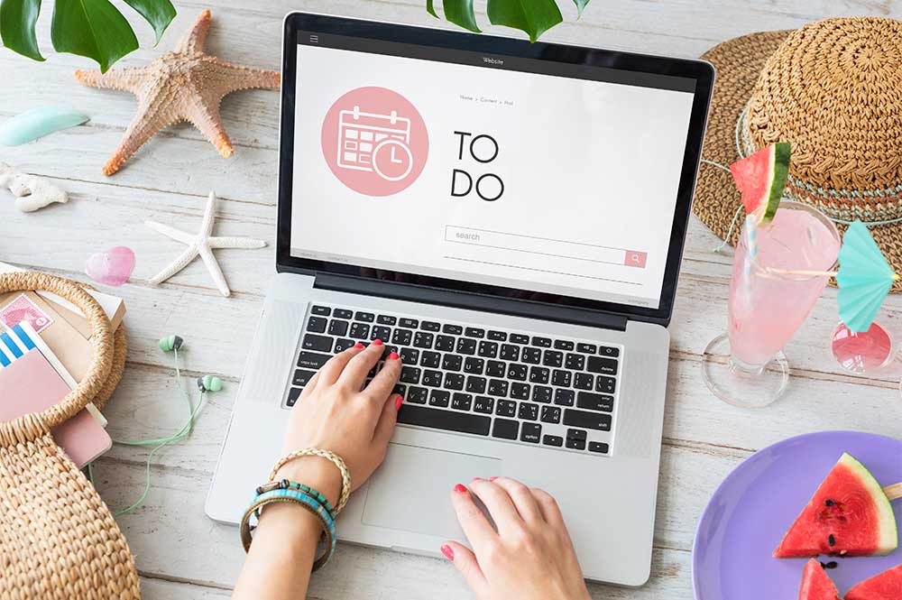 A person on a laptop that has "to-do" written on screen, checking things to launch a new website.