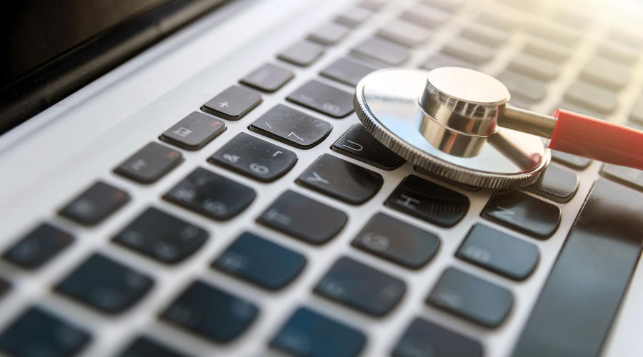 A laptop with a stethoscope on it, representing a website audit