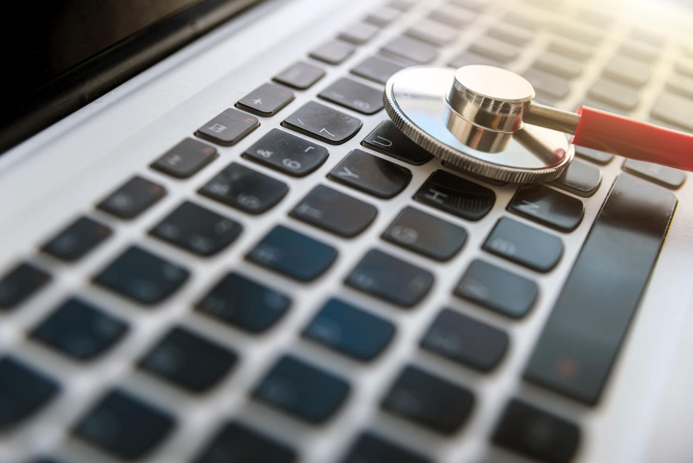 A laptop with a stethoscope on it, representing a website audit