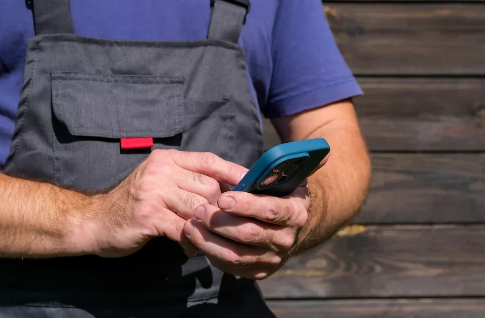 A tradesman checking the local SEO cost for his business on his phone